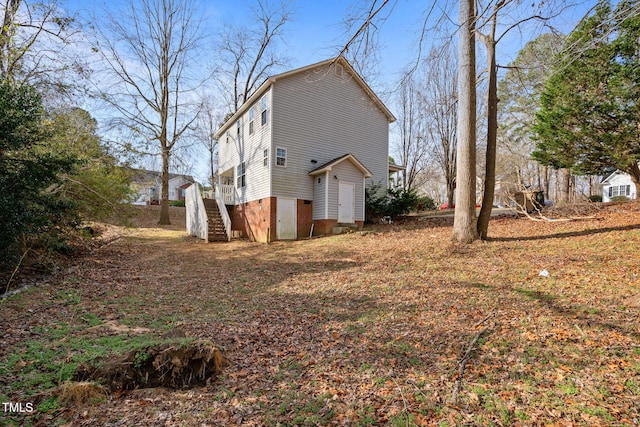 view of side of property with stairway