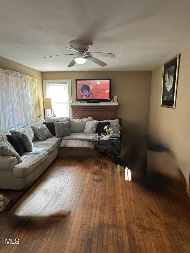 living room featuring a ceiling fan and wood finished floors