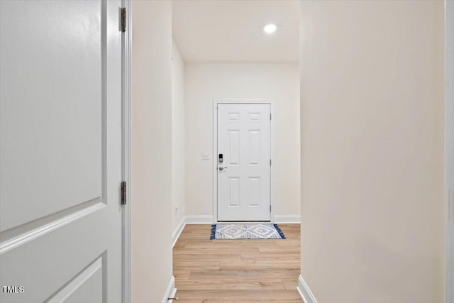 doorway with recessed lighting, light wood-style flooring, and baseboards