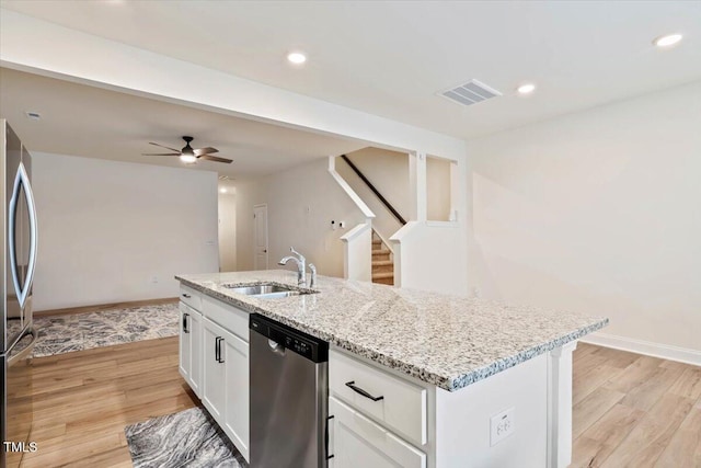 kitchen featuring appliances with stainless steel finishes, light wood-type flooring, a sink, and visible vents