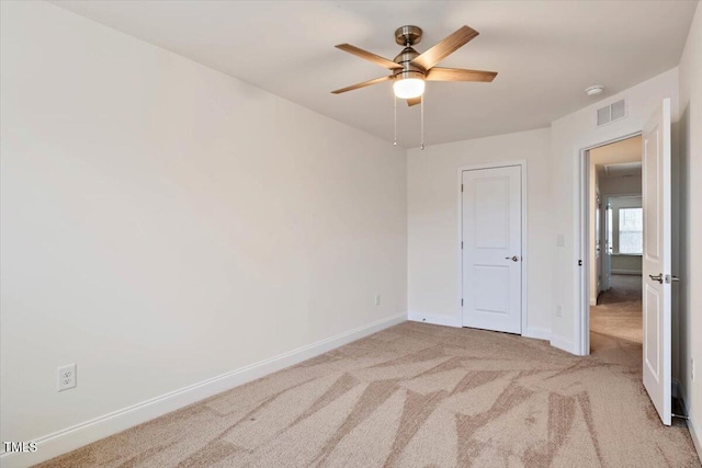 unfurnished bedroom featuring ceiling fan, carpet, visible vents, and baseboards