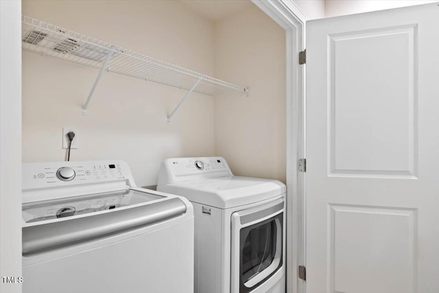 washroom with laundry area and washer and clothes dryer