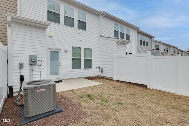 rear view of house with fence, a patio, and central air condition unit