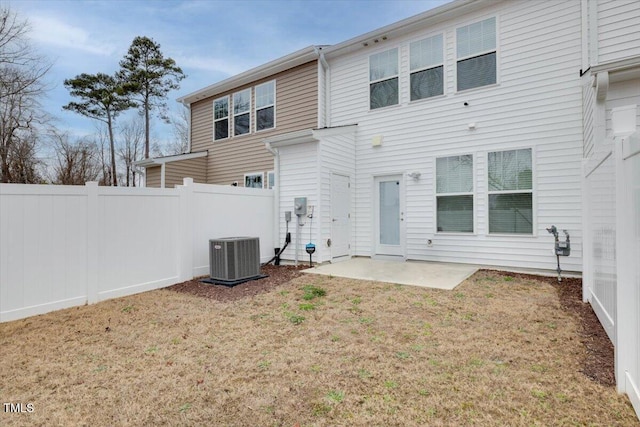 rear view of property with central AC unit, a lawn, a patio area, and fence