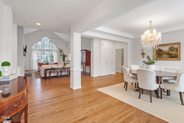 dining area featuring ornamental molding, decorative columns, light wood-style flooring, and ceiling fan with notable chandelier