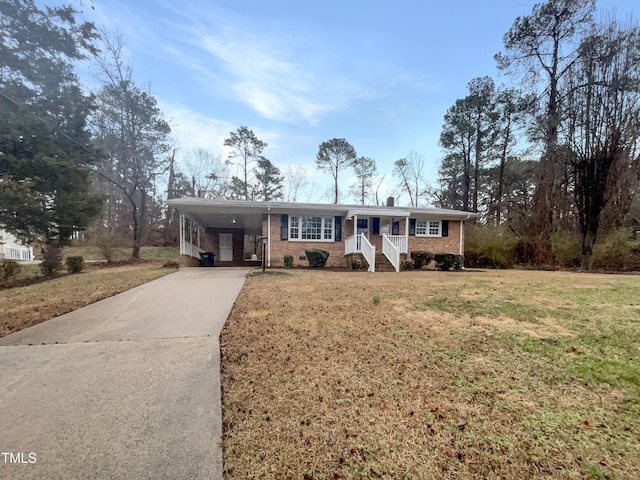 single story home featuring a carport, concrete driveway, a front lawn, and brick siding