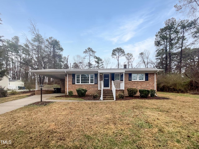 single story home featuring a carport, brick siding, driveway, and a front lawn