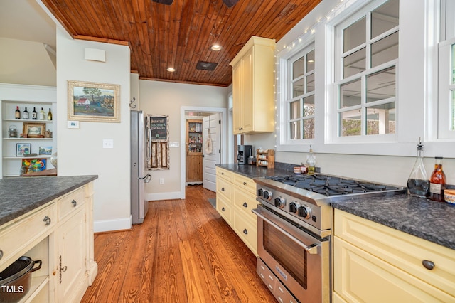 kitchen with stainless steel appliances, recessed lighting, wood finished floors, wooden ceiling, and baseboards