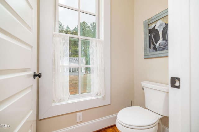 bathroom featuring toilet and baseboards