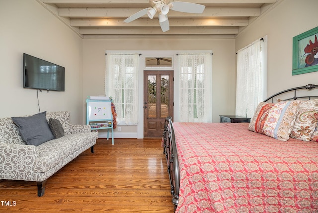 bedroom featuring ceiling fan, wood finished floors, beamed ceiling, access to exterior, and french doors