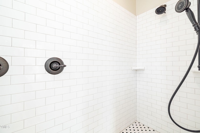 bathroom with a tile shower