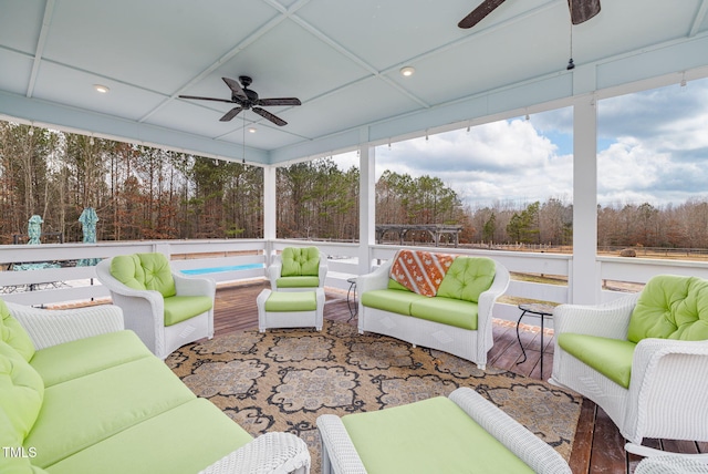 sunroom / solarium featuring a paneled ceiling and a ceiling fan