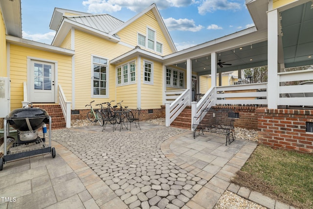 rear view of house featuring ceiling fan, a patio, metal roof, entry steps, and crawl space