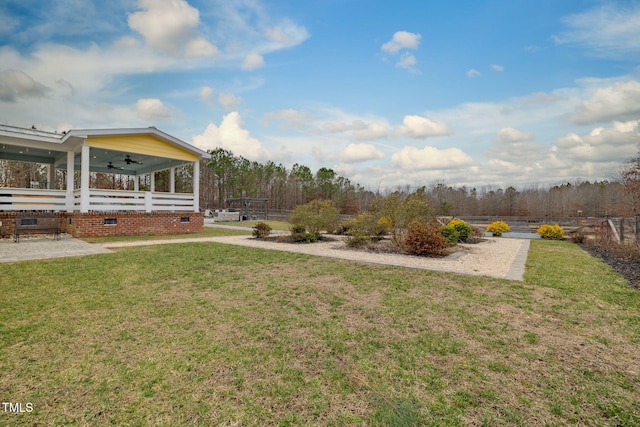 view of yard with ceiling fan