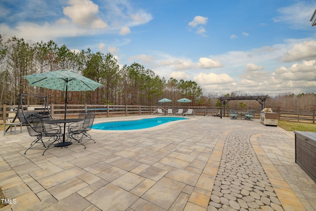 view of pool featuring a patio area, a fenced in pool, fence, and a pergola