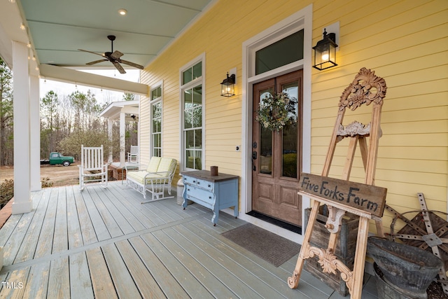 deck featuring a porch and a ceiling fan