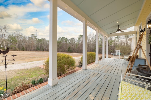 wooden terrace with a ceiling fan