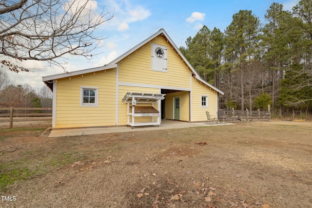 rear view of house with a yard, a patio area, and fence