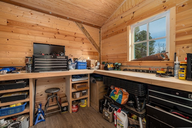 interior space with dark wood-style floors, butcher block counters, vaulted ceiling, and wooden walls