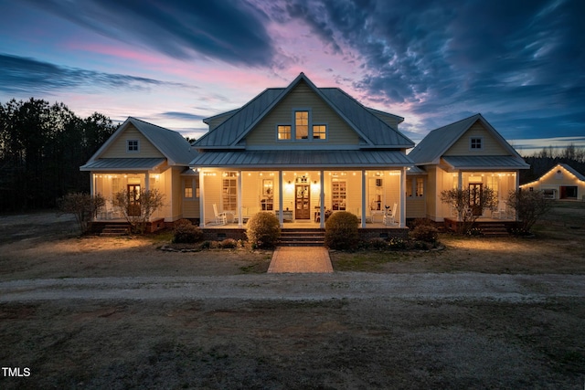 view of front of property with metal roof, a porch, and a standing seam roof