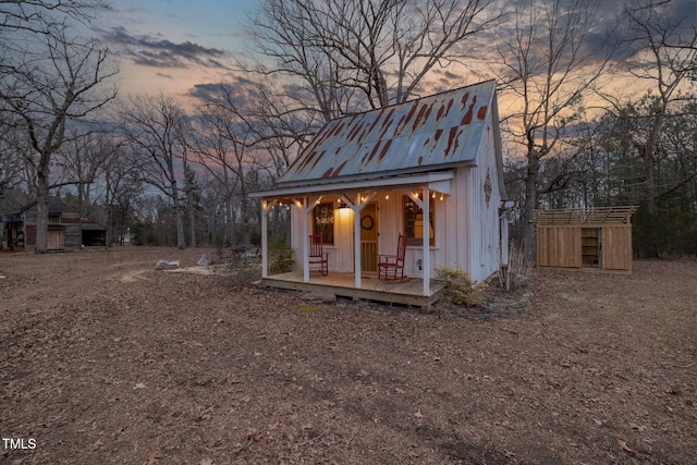 outdoor structure at dusk with an outbuilding