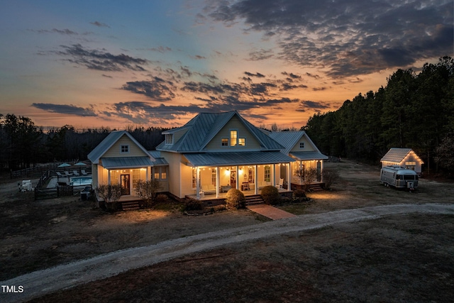 view of front of home featuring a porch, a standing seam roof, and metal roof