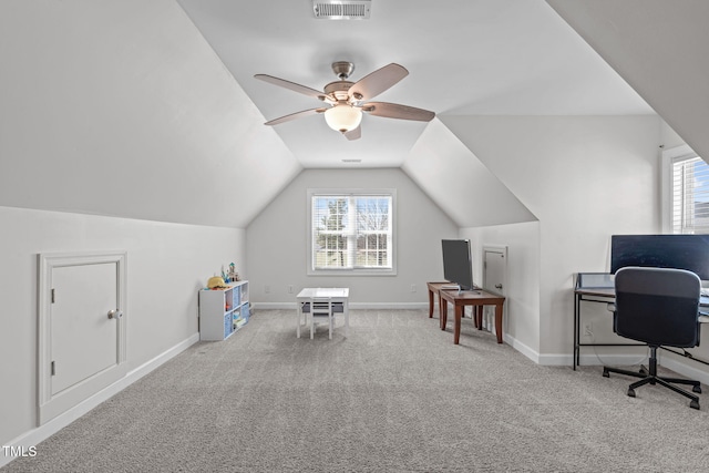 office featuring carpet, visible vents, vaulted ceiling, ceiling fan, and baseboards