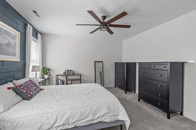 bedroom featuring carpet, visible vents, baseboards, and a ceiling fan