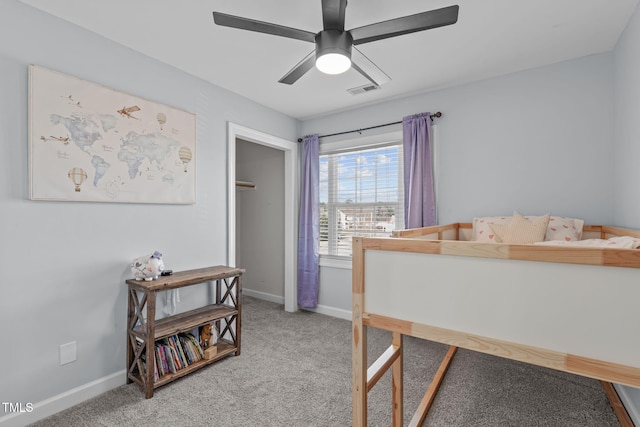 bedroom with light carpet, ceiling fan, visible vents, and baseboards