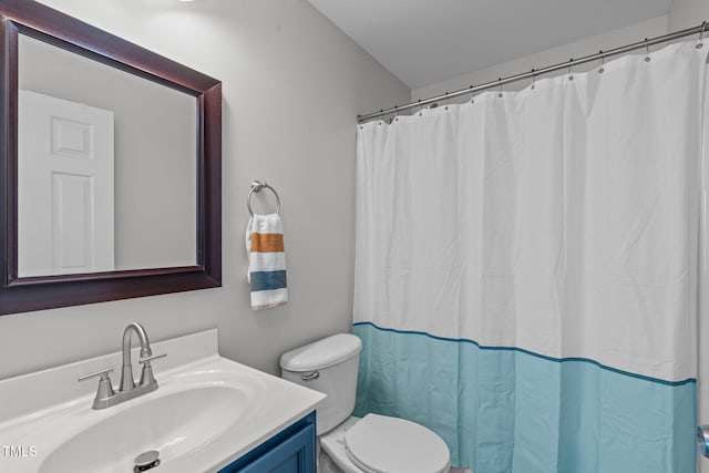 bathroom with toilet, a shower with shower curtain, and vanity