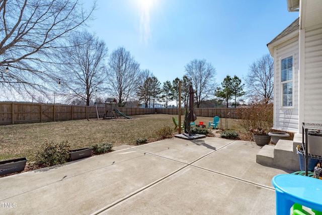 view of patio / terrace featuring a fenced backyard and a playground