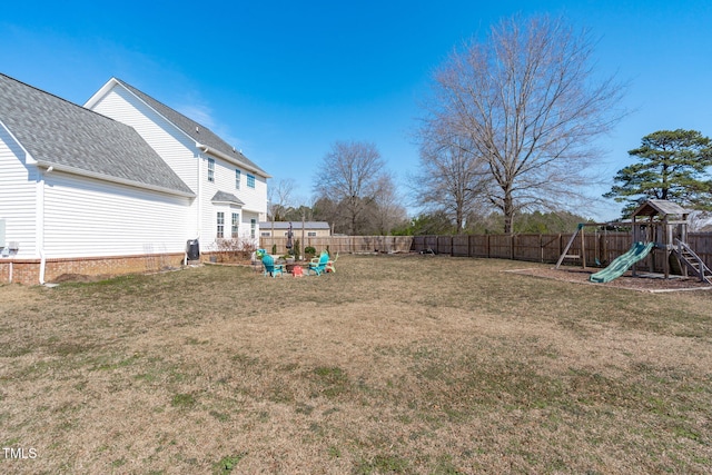 view of yard with a fenced backyard and a playground