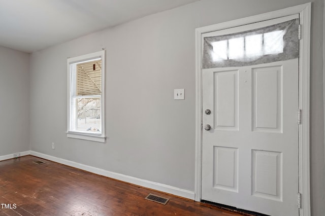 entrance foyer with dark wood finished floors, baseboards, and visible vents