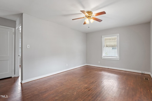 empty room featuring visible vents, ceiling fan, baseboards, and hardwood / wood-style flooring