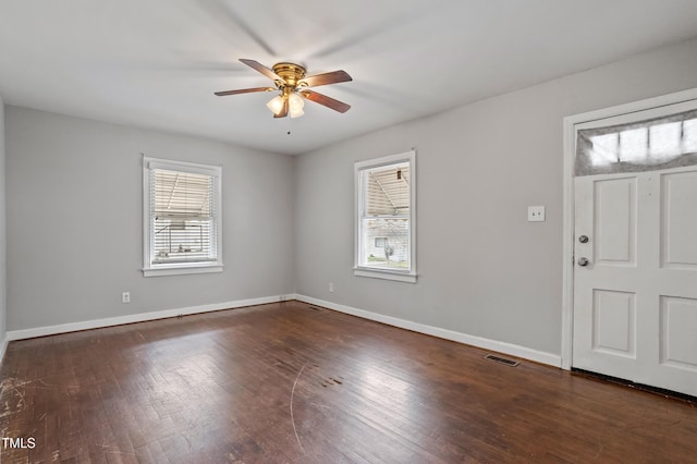 foyer entrance with visible vents, plenty of natural light, and hardwood / wood-style flooring