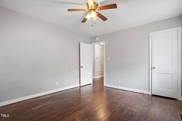 unfurnished bedroom featuring ceiling fan, visible vents, baseboards, and hardwood / wood-style floors