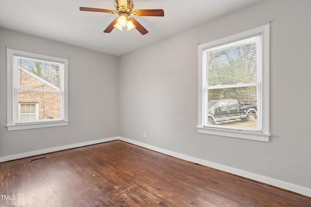 unfurnished room with visible vents, baseboards, ceiling fan, and hardwood / wood-style flooring