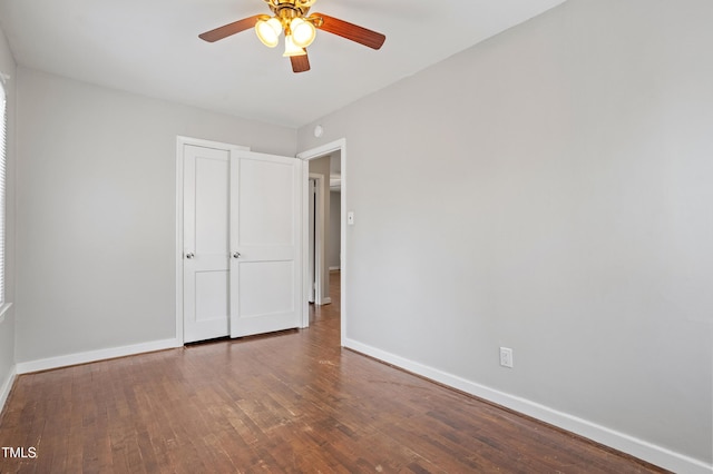 unfurnished bedroom with ceiling fan, baseboards, and wood-type flooring