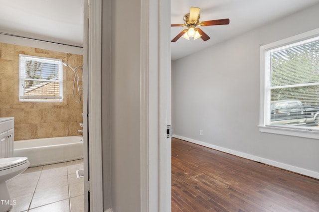 bathroom featuring tile patterned floors, baseboards, plenty of natural light, and vanity