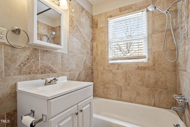 full bath with bathing tub / shower combination, tile walls, and vanity