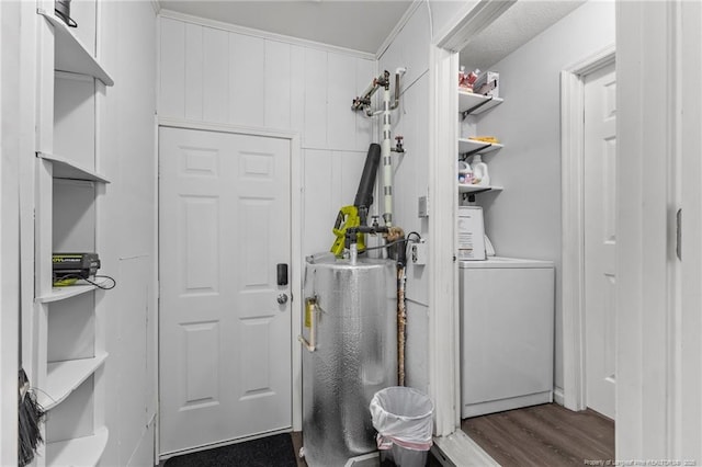 laundry room featuring washer / clothes dryer, water heater, dark wood-style flooring, and laundry area