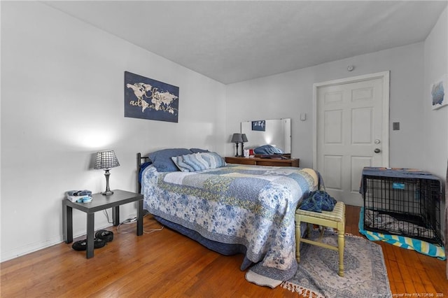 bedroom featuring wood finished floors and baseboards