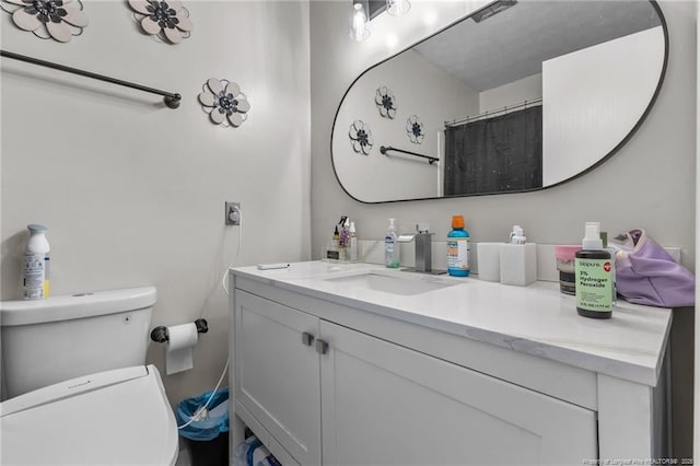 bathroom with toilet and vanity