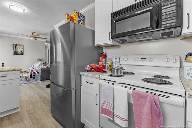 kitchen featuring black microwave, light countertops, white electric range oven, and white cabinets