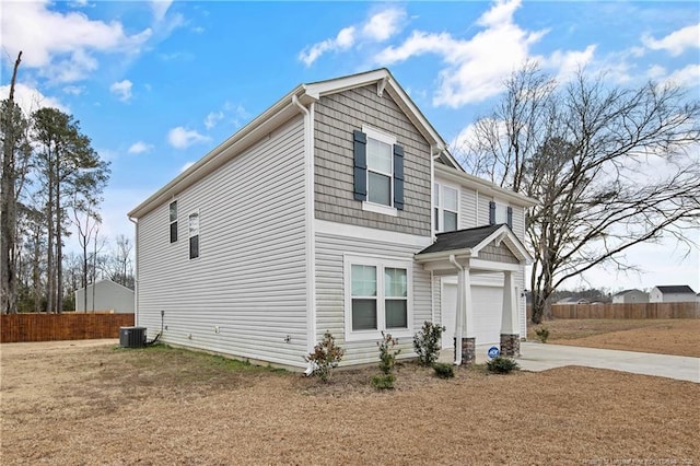 view of property exterior with driveway, cooling unit, and fence