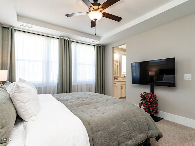 bedroom with connected bathroom, a ceiling fan, visible vents, baseboards, and carpet