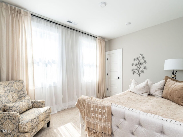 bedroom with carpet floors, multiple windows, and visible vents