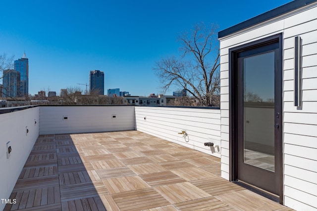 view of patio / terrace with a view of city and a balcony