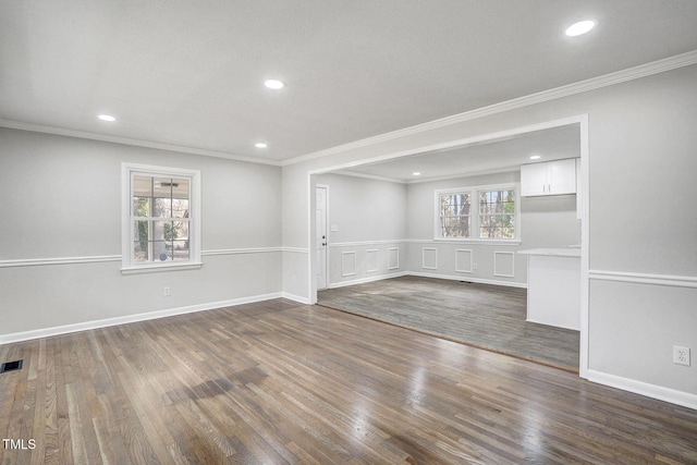 spare room featuring dark wood-style floors, crown molding, visible vents, and recessed lighting