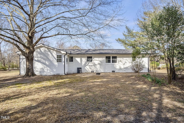 rear view of house with crawl space, brick siding, a yard, and central air condition unit